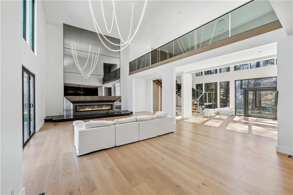 1355 Moores Mill Road Northwest Atlanta, GA 30327 - Photo 7 of 45 a kitchen with stainless steel appliances kitchen island wooden floors and refrigerator