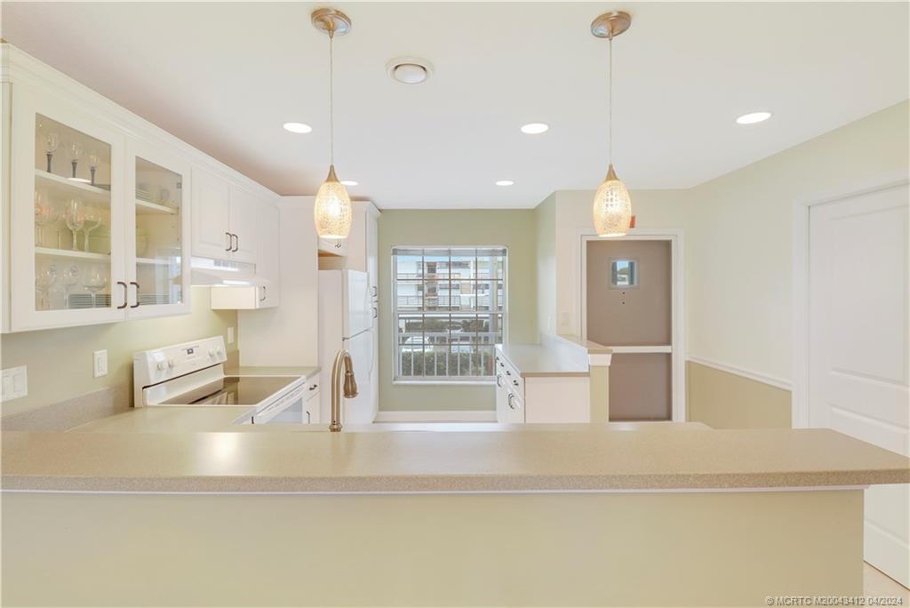 1864 Southwest Palm City Road, Unit 202 Stuart, FL 34994 - Photo 12 of 29 a view of kitchen with granite countertop a sink and a refrigerator
