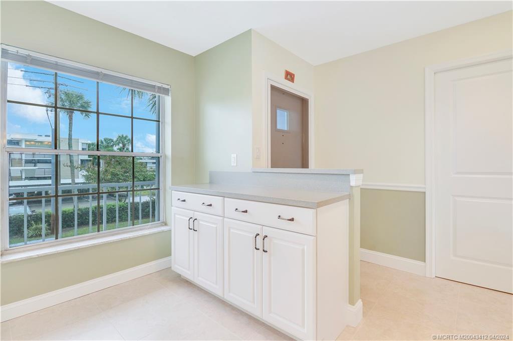 1864 Southwest Palm City Road, Unit 202 Stuart, FL 34994 - Photo 14 of 29 a spacious bathroom with a granite countertop sink and a mirror