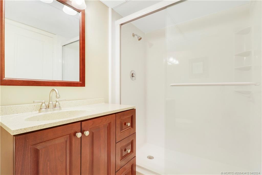 1864 Southwest Palm City Road, Unit 202 Stuart, FL 34994 - Photo 23 of 29 a bathroom with a sink and a mirror