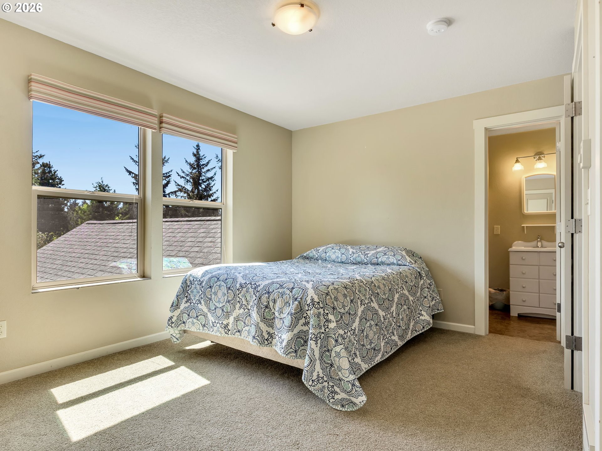 1077 Southwest Ridge Road Warrenton, OR 97146 - Photo 37 of 46 a bedroom with a bed and a window