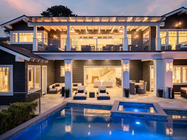 a living room with furniture and large windows