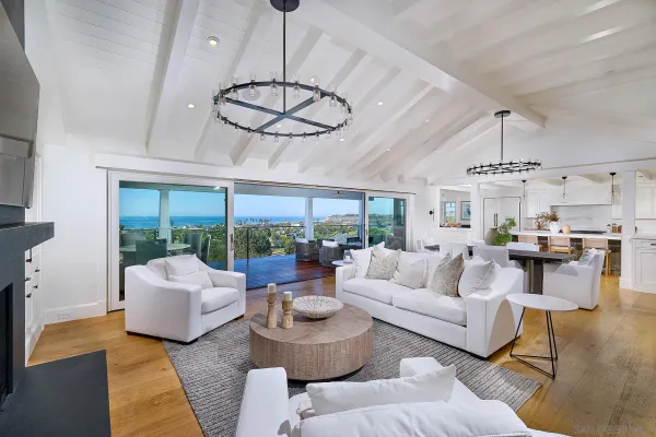 a large white kitchen with a large window