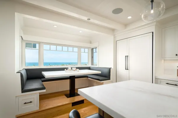a living room with furniture and floor to ceiling windows