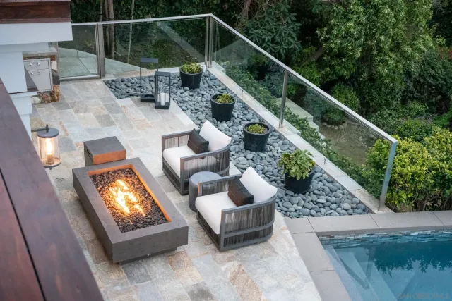 a living room with furniture and large windows