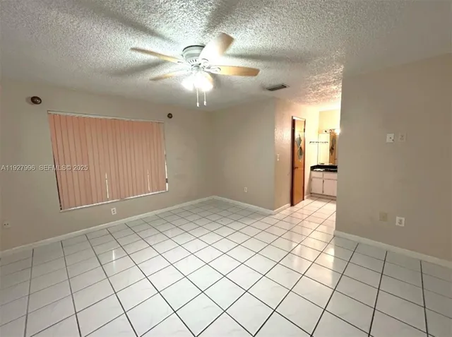 a view of a porch with wooden floor and a yard