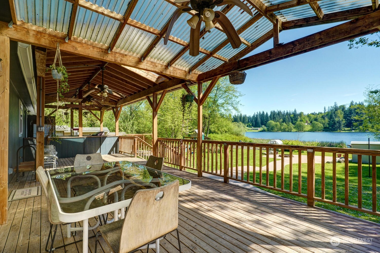1722 Sunday Lake Road Stanwood, WA 98292 - Photo 22 of 32 a view of a patio with table and chairs with wooden floor