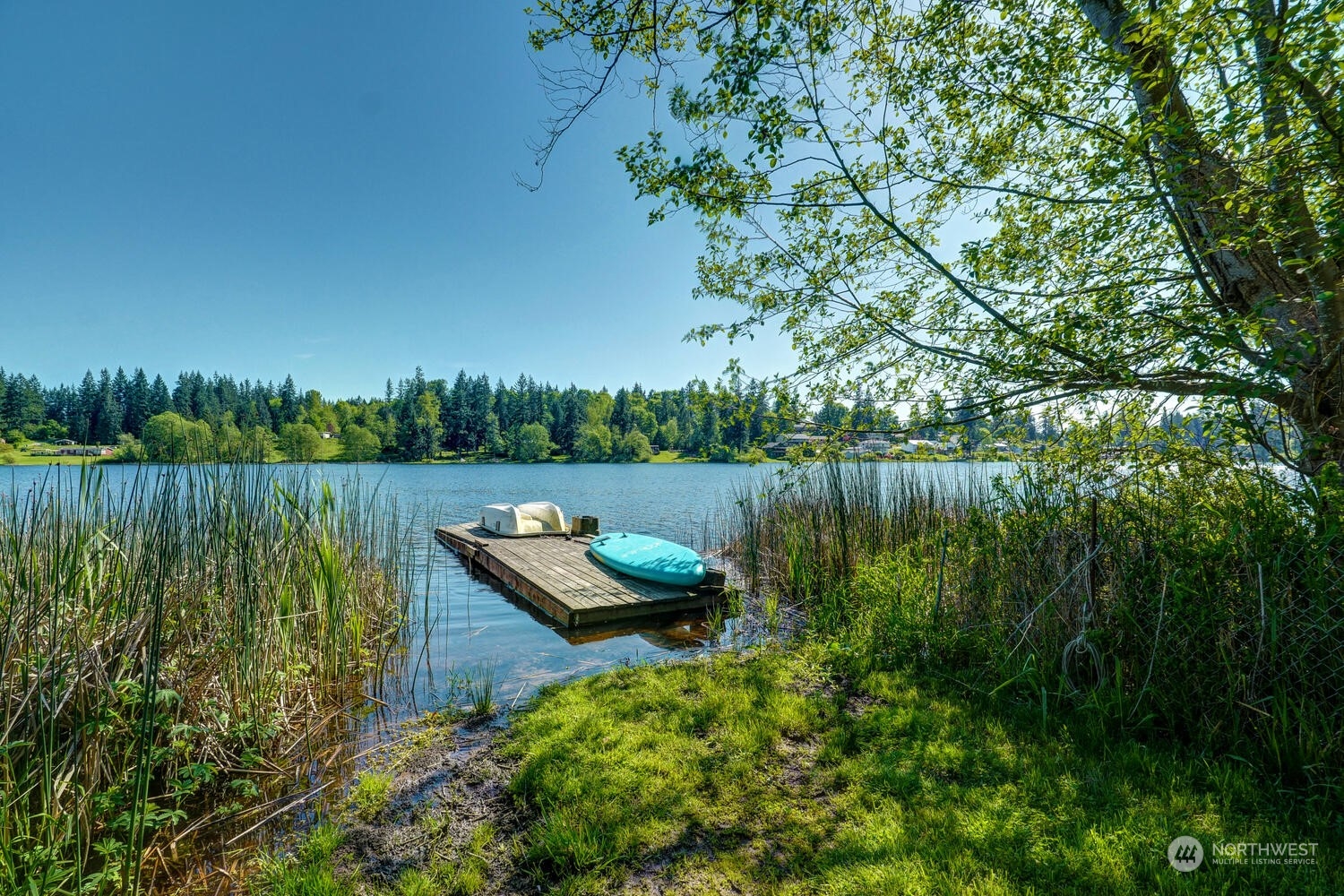 1722 Sunday Lake Road Stanwood, WA 98292 - Photo 24 of 32 a view of a lake with a house in the background