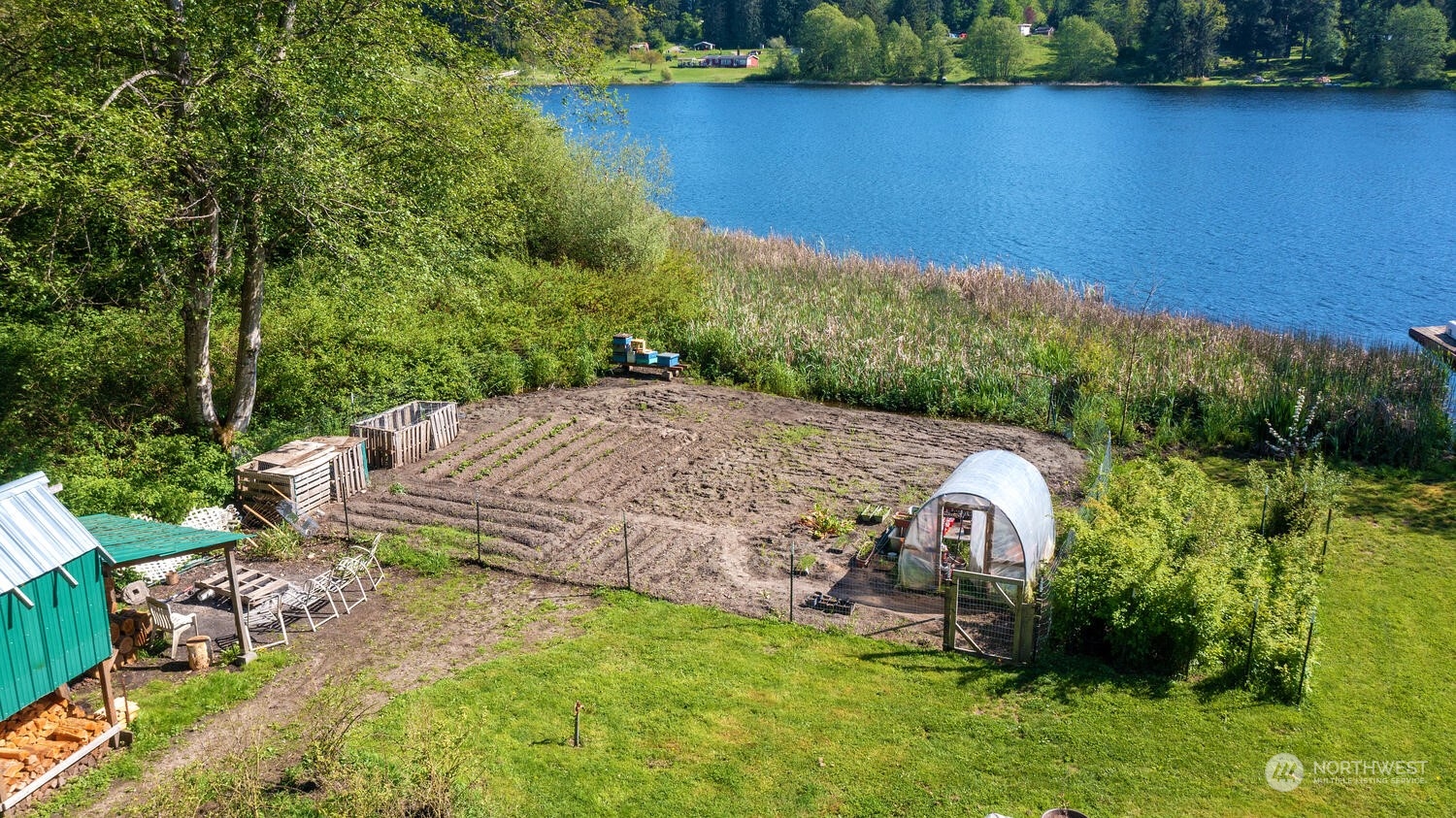1722 Sunday Lake Road Stanwood, WA 98292 - Photo 27 of 32 a view of a backyard with plants and lake