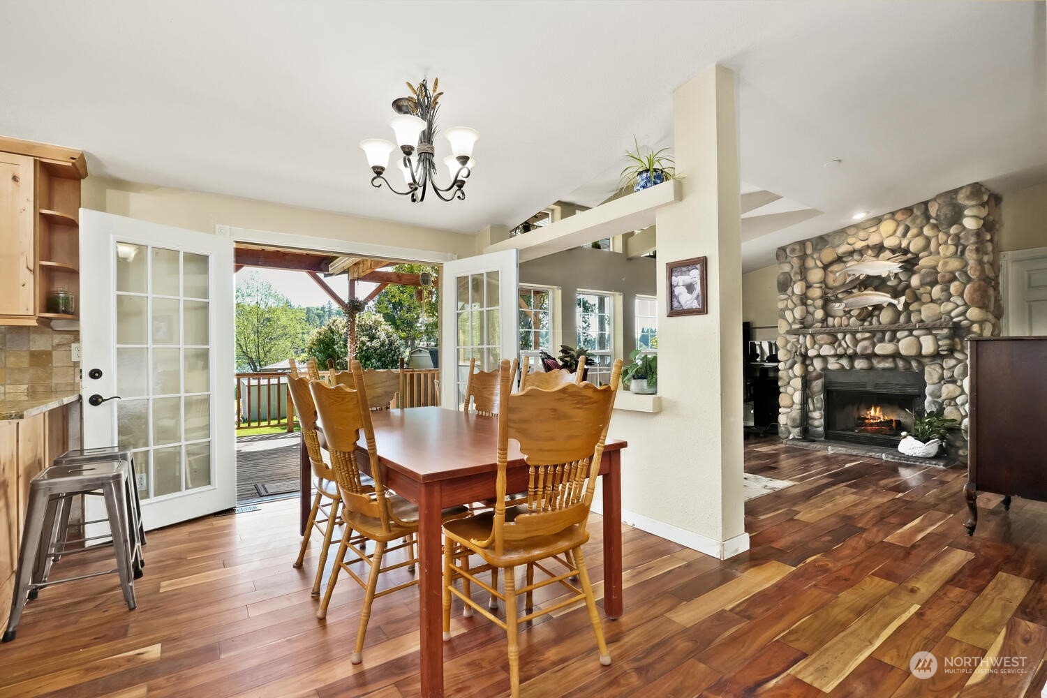 1722 Sunday Lake Road Stanwood, WA 98292 - Photo 6 of 32 a view of a dining room with furniture window and wooden floor
