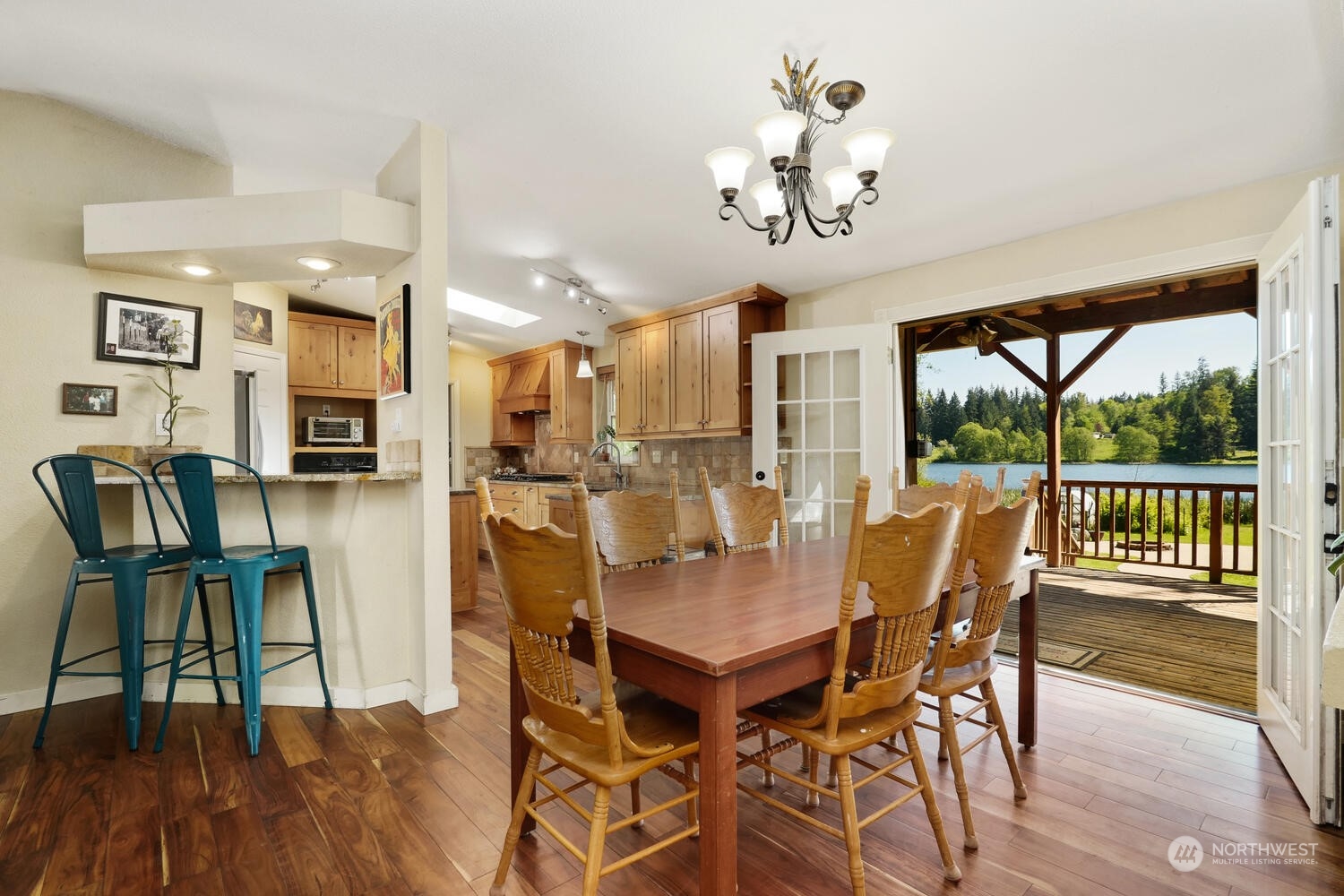 1722 Sunday Lake Road Stanwood, WA 98292 - Photo 7 of 32 a view of a dining room with furniture a chandelier and wooden floor