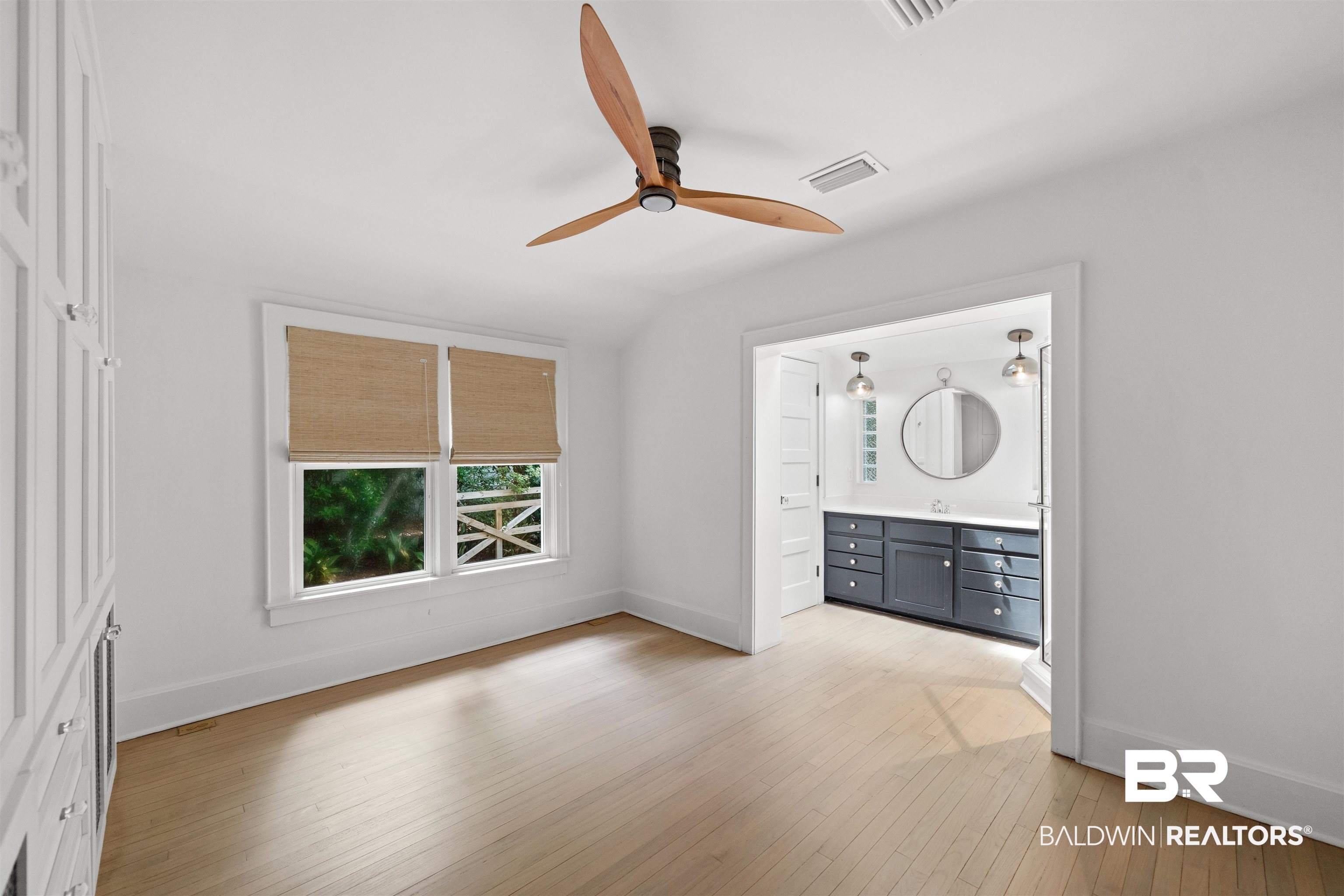 106 White Avenue Fairhope, AL 36532 - Photo 15 of 35 Unfurnished bedroom featuring light wood finished floors, ensuite bathroom, and ceiling fan