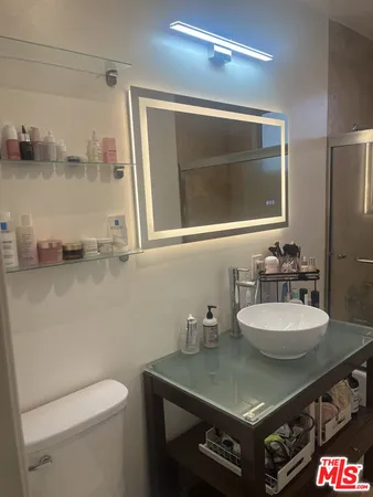 a bathroom with a glass shower door