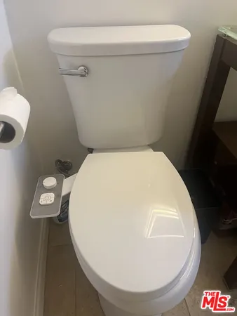 a bedroom with a bed and a night stand