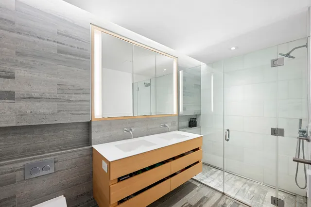 a bedroom with a bed and a couch next to a window