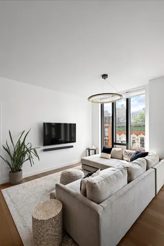 a view of room with furniture and floor to ceiling window