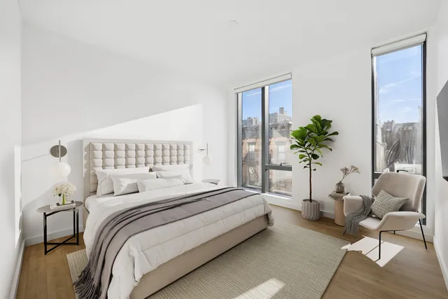 a living room with furniture a flat screen tv and a large window