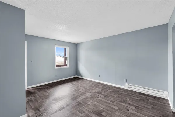 a kitchen with a stove and white cabinets
