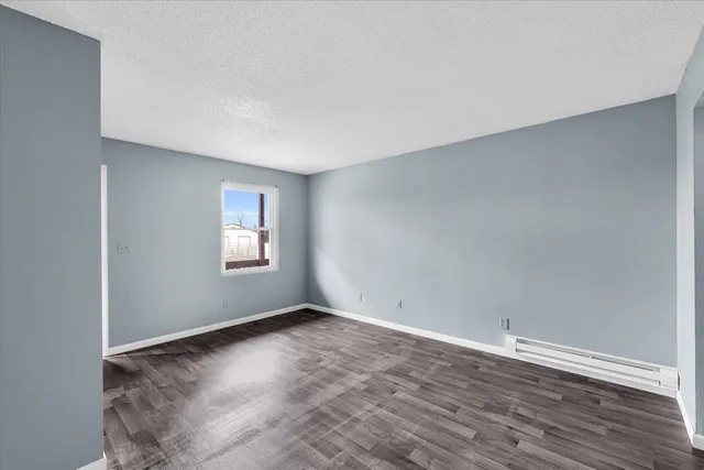 a kitchen with a stove and white cabinets