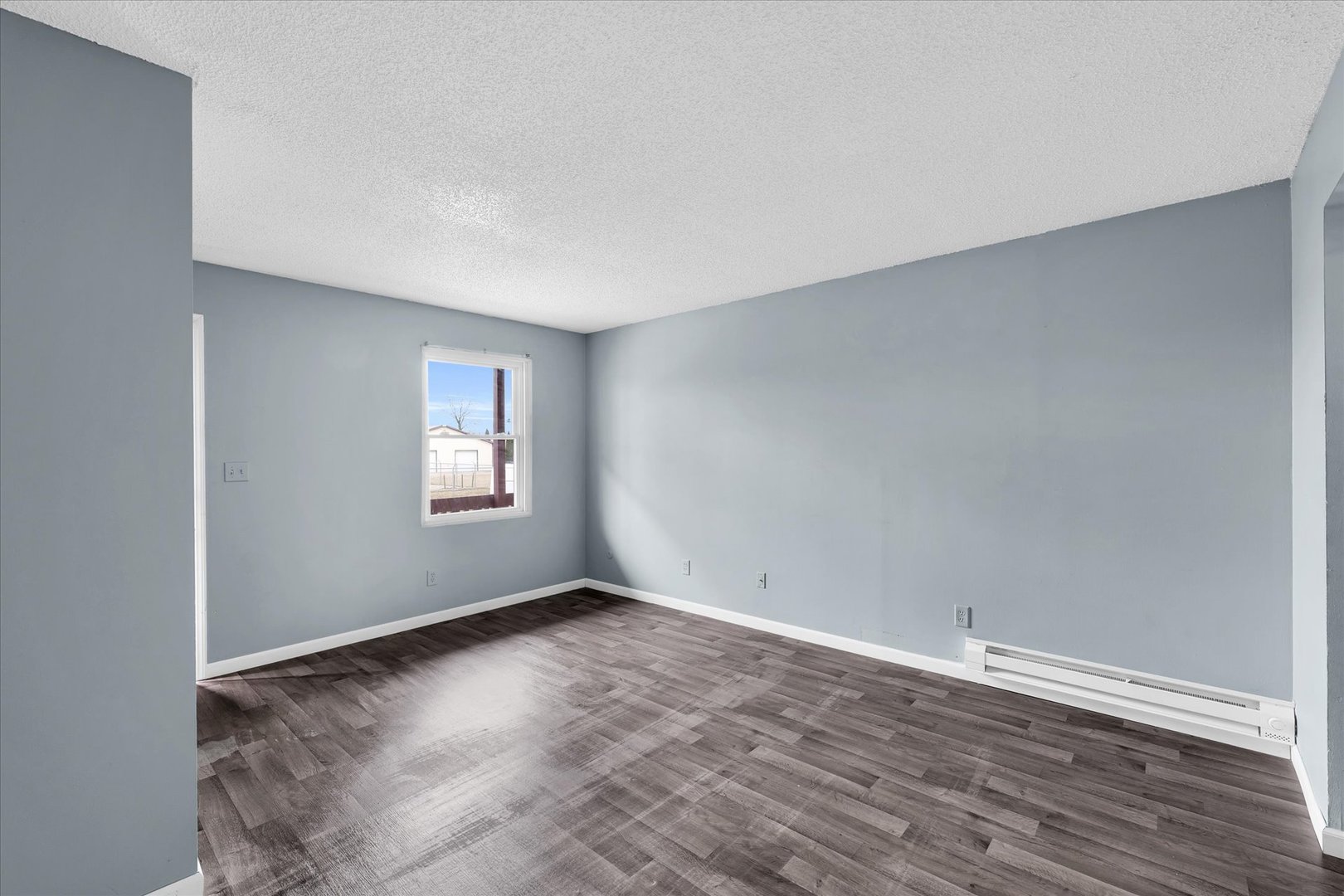 1740-1760 South Fairview Avenue Decatur, IL 62521 - Photo 15 of 26 a view of an empty room with wooden floor and a window