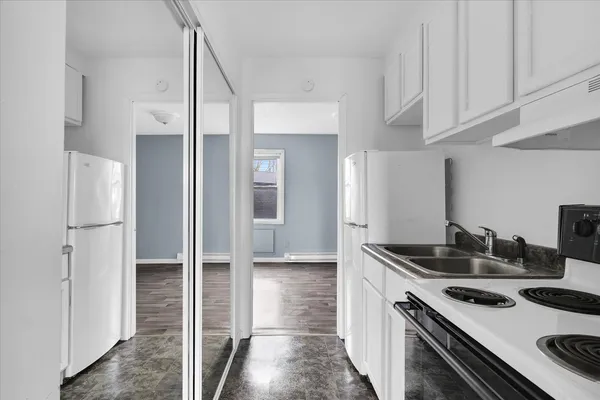 a kitchen with cabinets appliances and a window