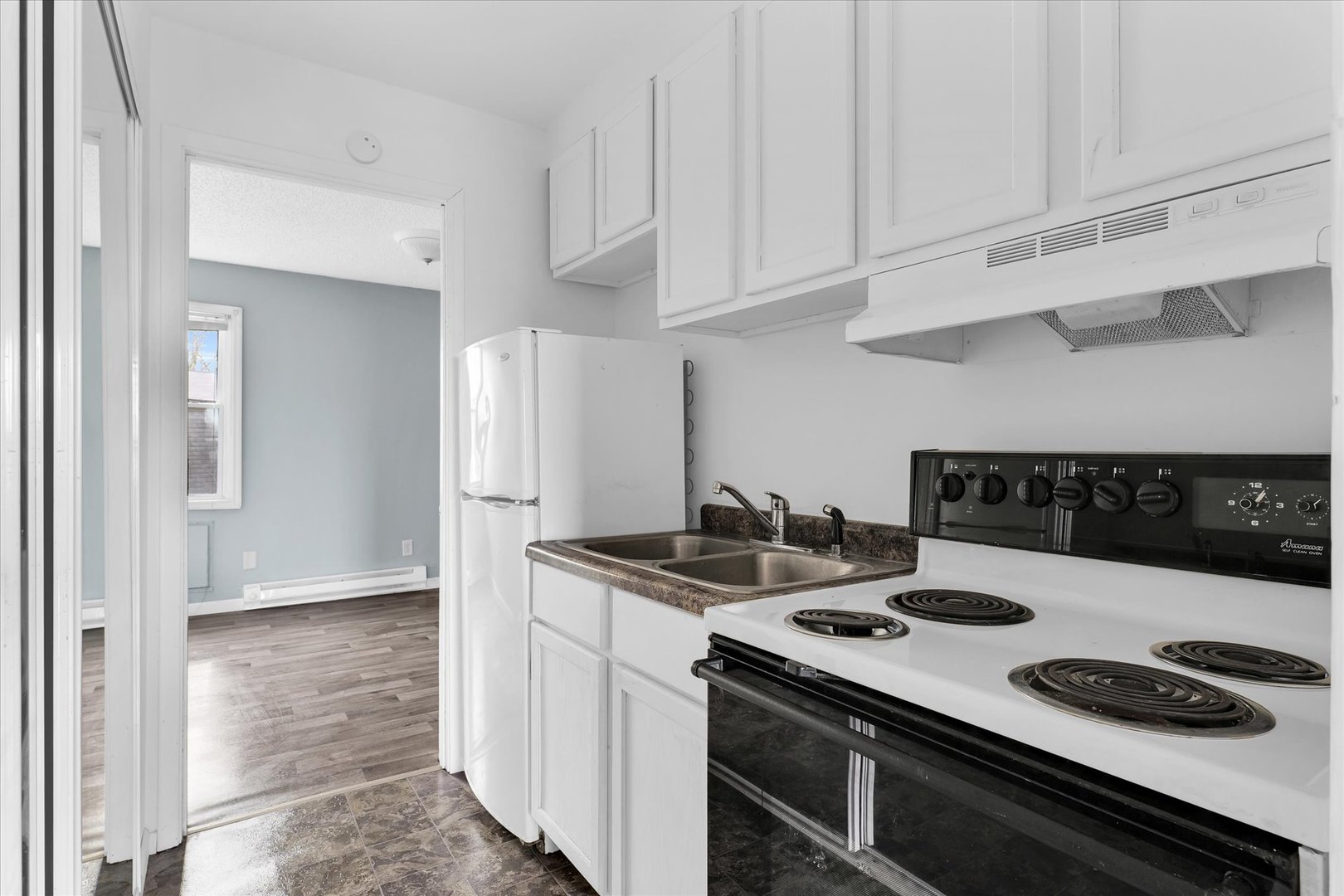 1740-1760 South Fairview Avenue Decatur, IL 62521 - Photo 17 of 26 a kitchen with a stove and white cabinets