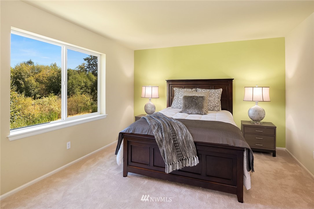 3617 183rd Place Southeast Bothell, WA 98012 - Photo 13 of 27 a bedroom with a bed lamp and a large window