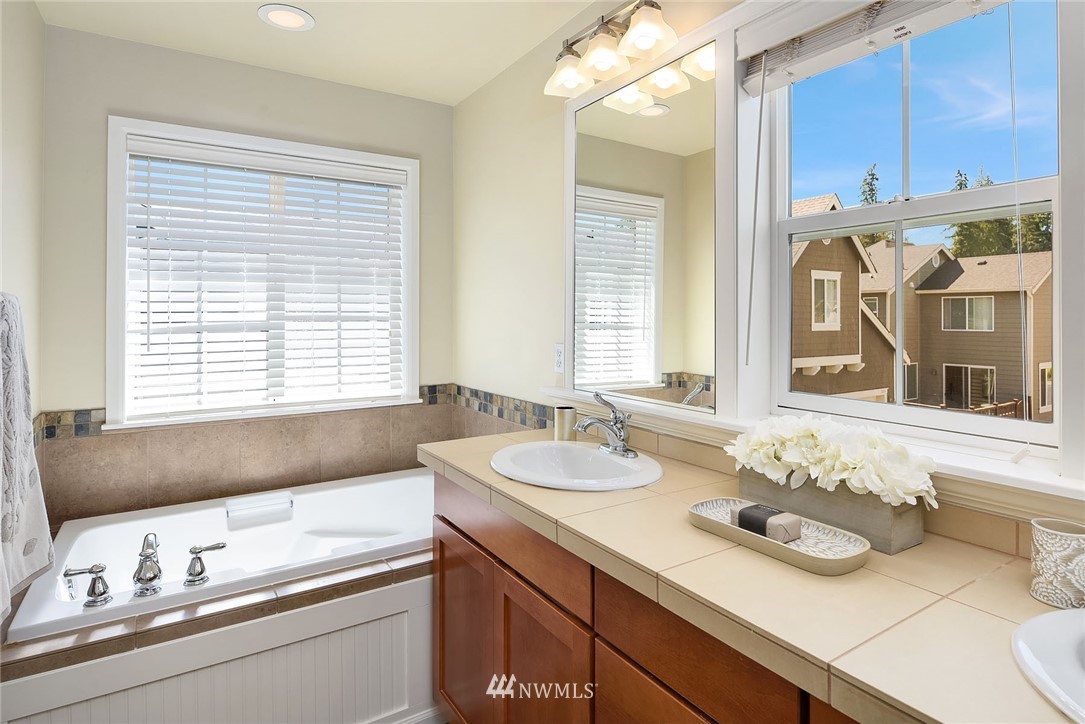 3617 183rd Place Southeast Bothell, WA 98012 - Photo 15 of 27 a bathroom with a granite countertop sink and a large mirror