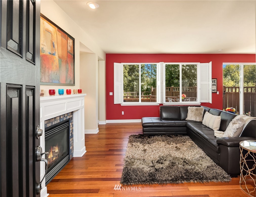 3617 183rd Place Southeast Bothell, WA 98012 - Photo 6 of 27 a living room with furniture a large window and a fireplace