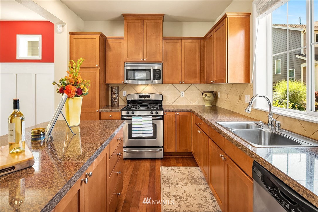 3617 183rd Place Southeast Bothell, WA 98012 - Photo 10 of 27 a kitchen with stainless steel appliances a sink stove and a granite counter top