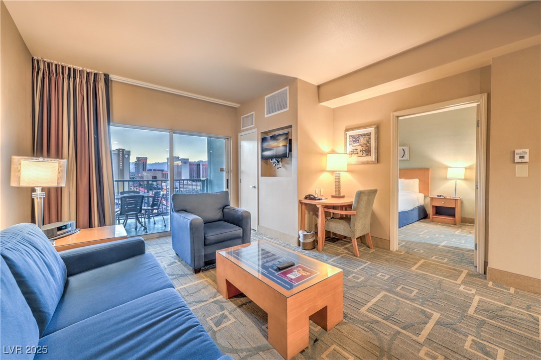 211 East Flamingo Road, Unit 1402 Las Vegas, NV 89169 - Photo 10 of 43 Living area with a skyline view and carpet flooring