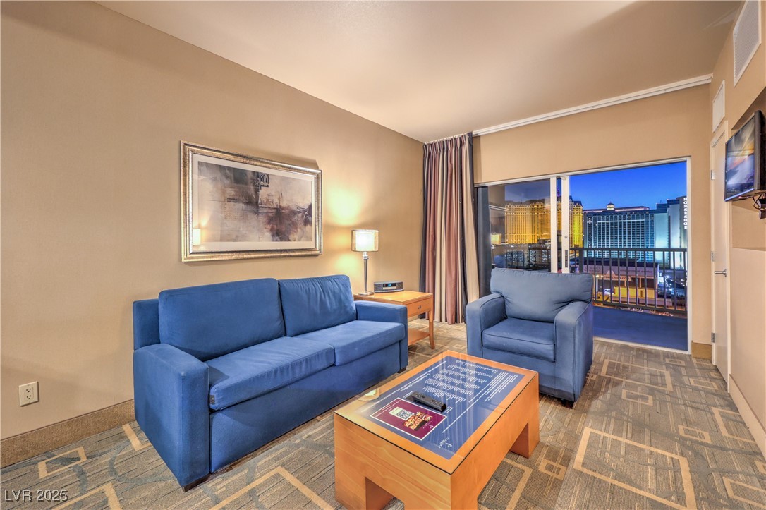 211 East Flamingo Road, Unit 1402 Las Vegas, NV 89169 - Photo 11 of 43 Carpeted living area featuring baseboards