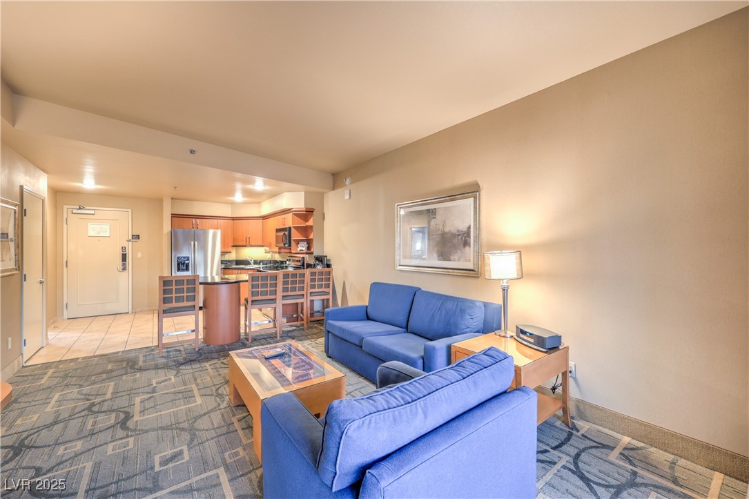 211 East Flamingo Road, Unit 1402 Las Vegas, NV 89169 - Photo 13 of 43 Living area featuring light colored carpet and baseboards