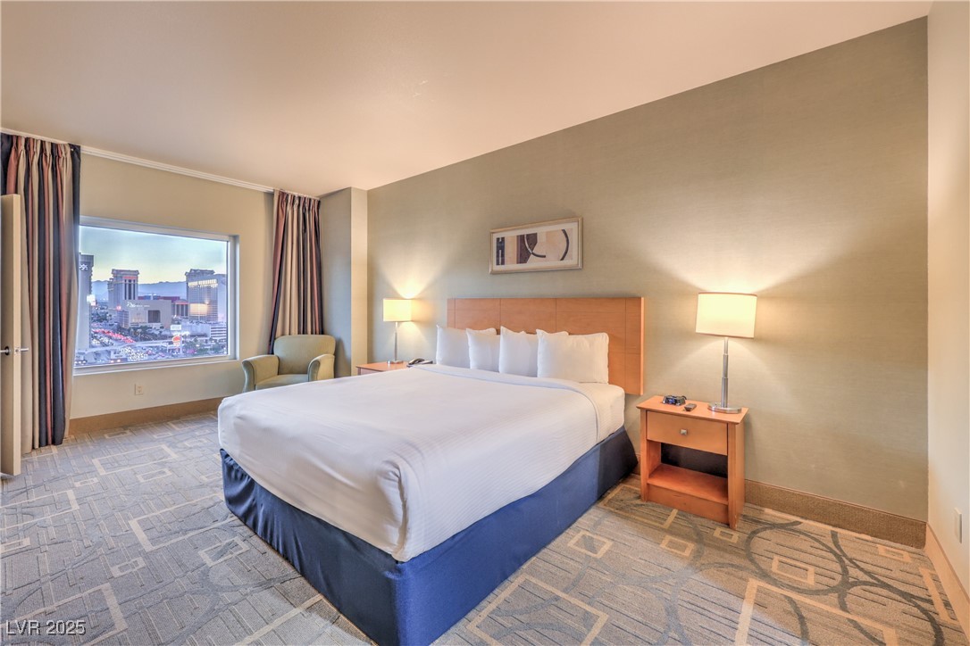 211 East Flamingo Road, Unit 1402 Las Vegas, NV 89169 - Photo 16 of 43 Bedroom featuring a city view and carpet