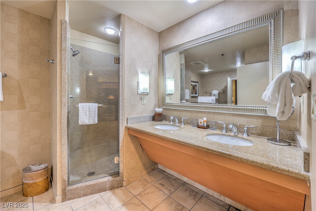 211 East Flamingo Road, Unit 1402 Las Vegas, NV 89169 - Photo 23 of 43 Bathroom with double vanity, a shower stall, and light tile patterned flooring