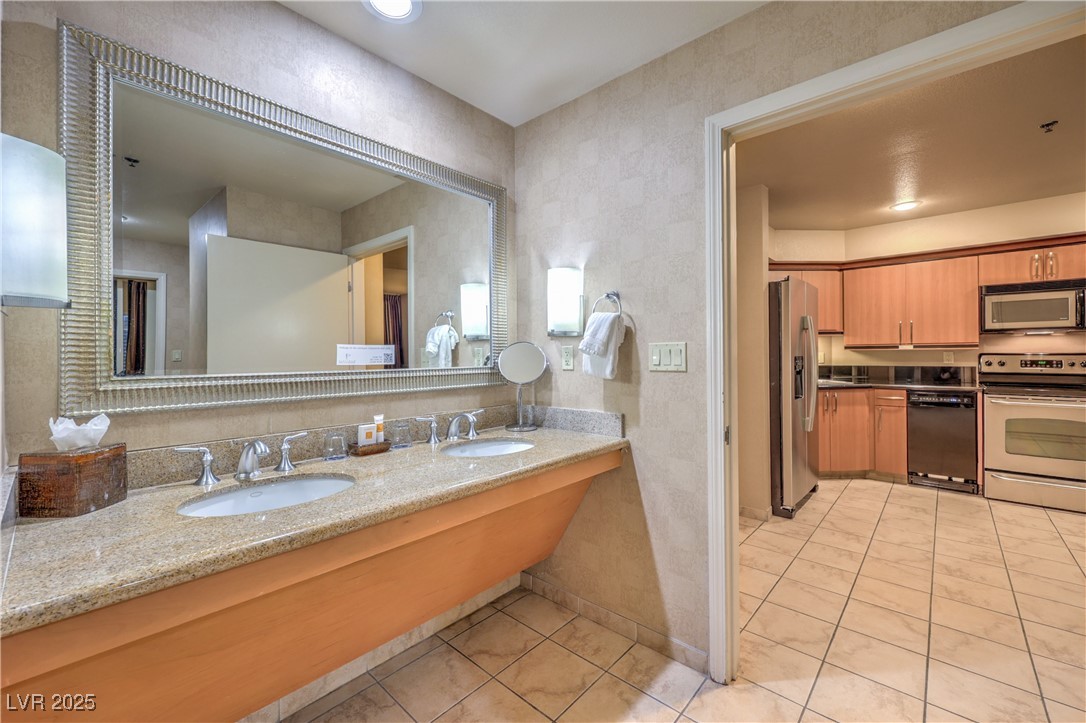 211 East Flamingo Road, Unit 1402 Las Vegas, NV 89169 - Photo 24 of 43 Bathroom featuring double vanity and light tile patterned flooring