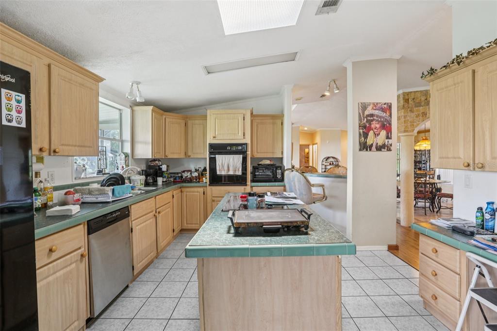 29235 Bayhead Road Dade City, FL 33523 - Photo 11 of 71 a kitchen with kitchen island granite countertop a sink stove and refrigerator