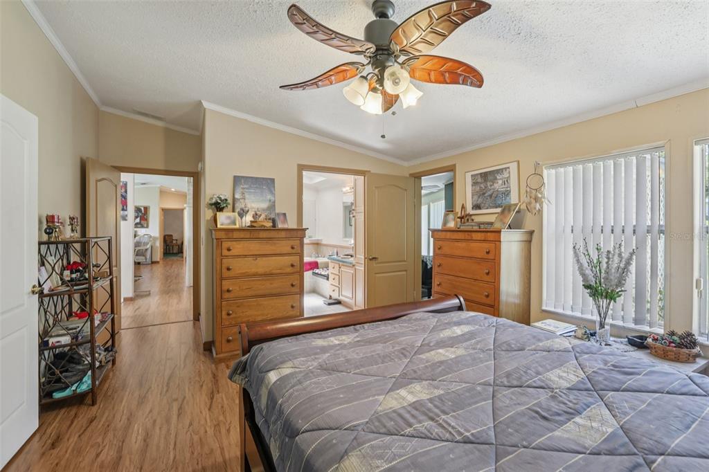 29235 Bayhead Road Dade City, FL 33523 - Photo 17 of 71 a bedroom with a bed and a chandelier