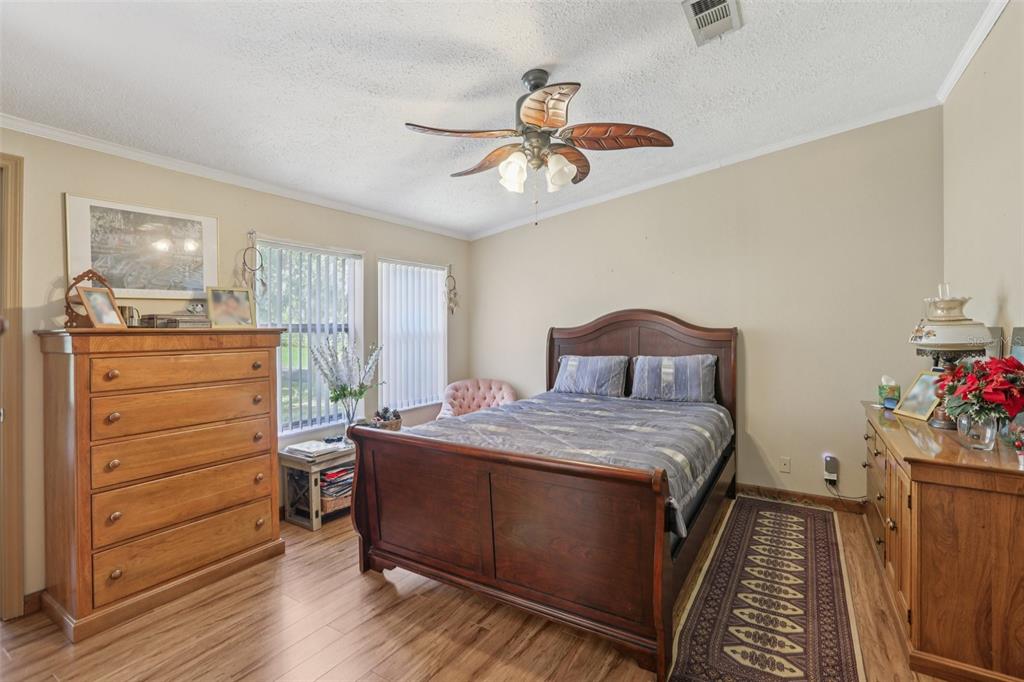 29235 Bayhead Road Dade City, FL 33523 - Photo 18 of 71 a bedroom with a bed and a chandelier