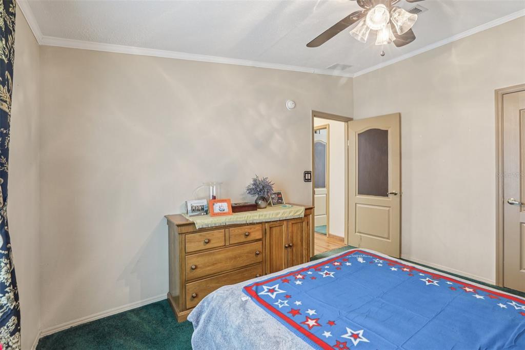 29235 Bayhead Road Dade City, FL 33523 - Photo 22 of 71 a bedroom with a bed and a dresser in it