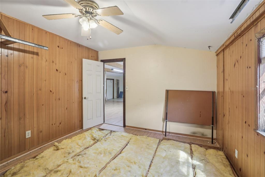 29235 Bayhead Road Dade City, FL 33523 - Photo 29 of 71 a view of a bedroom with a chandelier fan