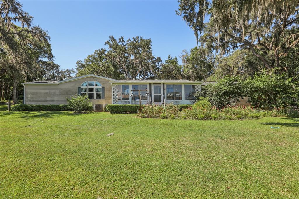 29235 Bayhead Road Dade City, FL 33523 - Photo 46 of 71 a view of a house with backyard and sitting area