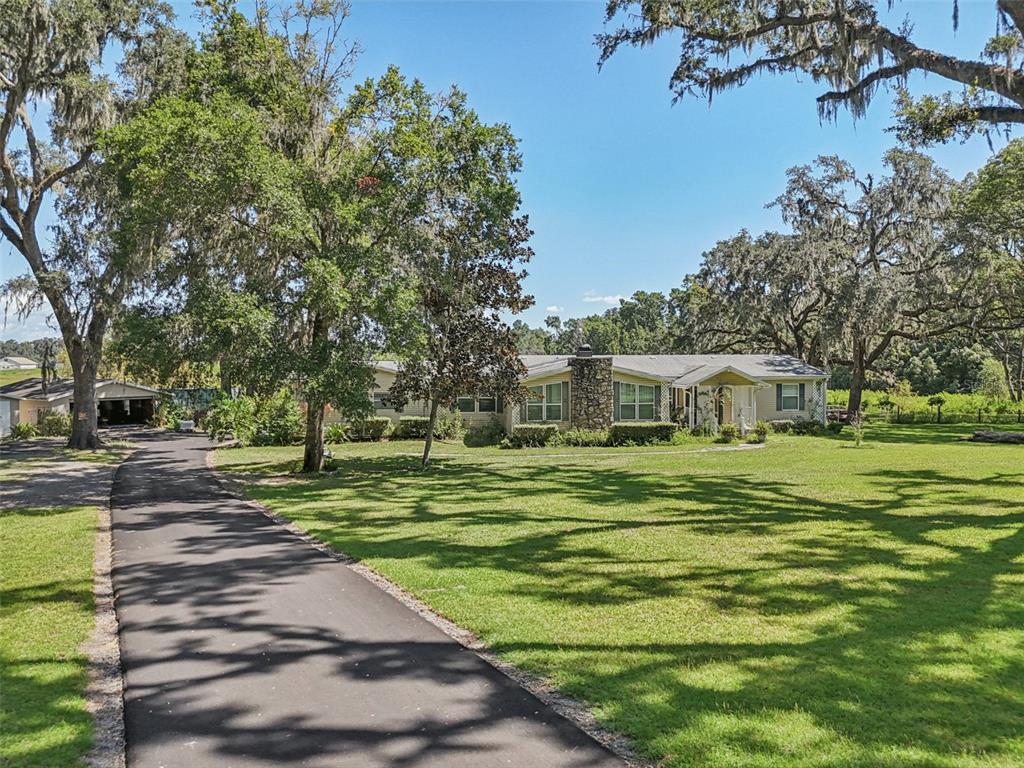 29235 Bayhead Road Dade City, FL 33523 - Photo 52 of 71 a front view of a house with a yard