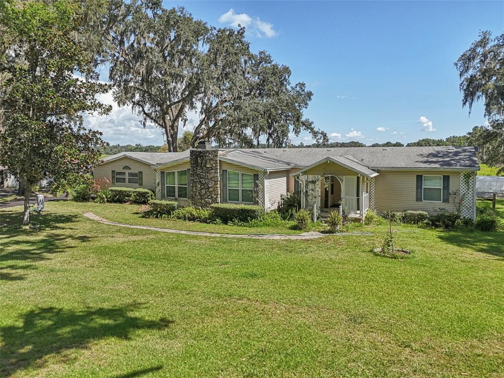 29235 Bayhead Road Dade City, FL 33523 - Photo 53 of 71 a front view of a house with a garden