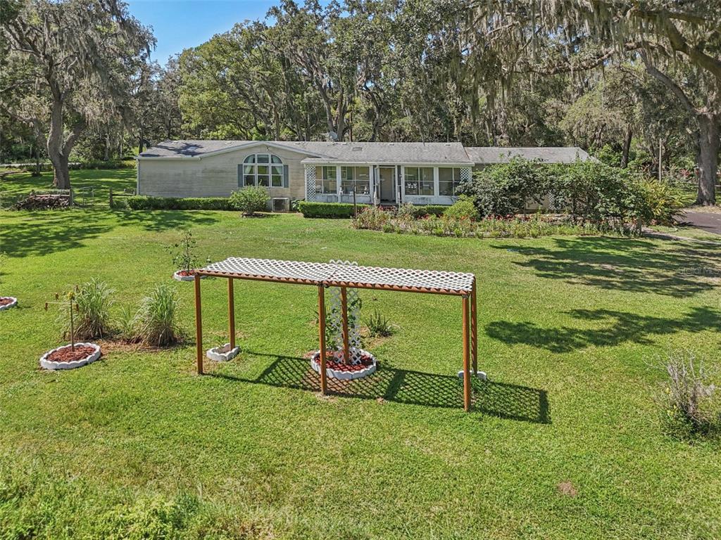 29235 Bayhead Road Dade City, FL 33523 - Photo 60 of 71 a view of a house with a yard table and chairs
