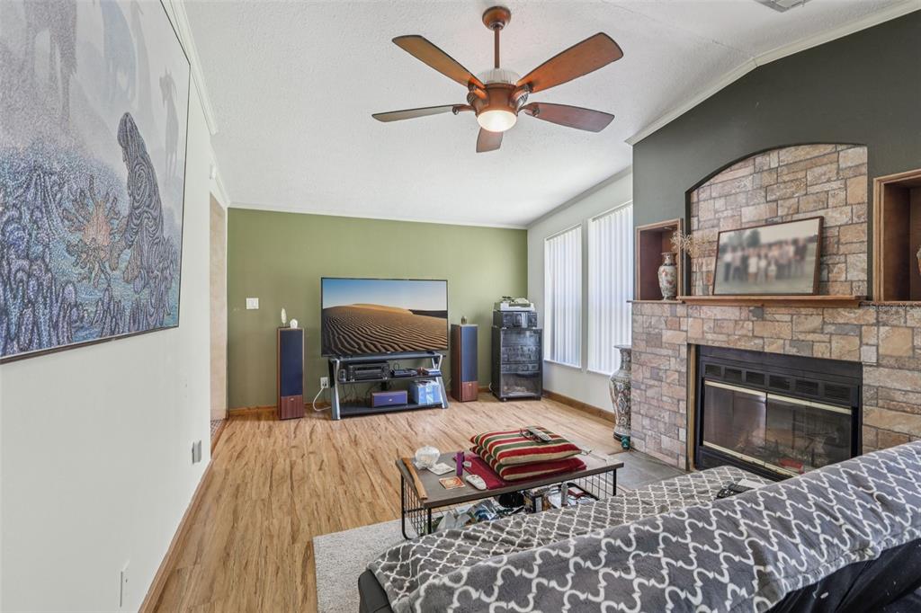 29235 Bayhead Road Dade City, FL 33523 - Photo 7 of 71 a living room with furniture fireplace and flat screen tv