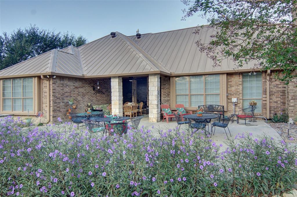 272 Edward Farris Road Weatherford, TX 76085 - Photo 34 of 40 Expansive concrete patio with brick exterior and metal roof