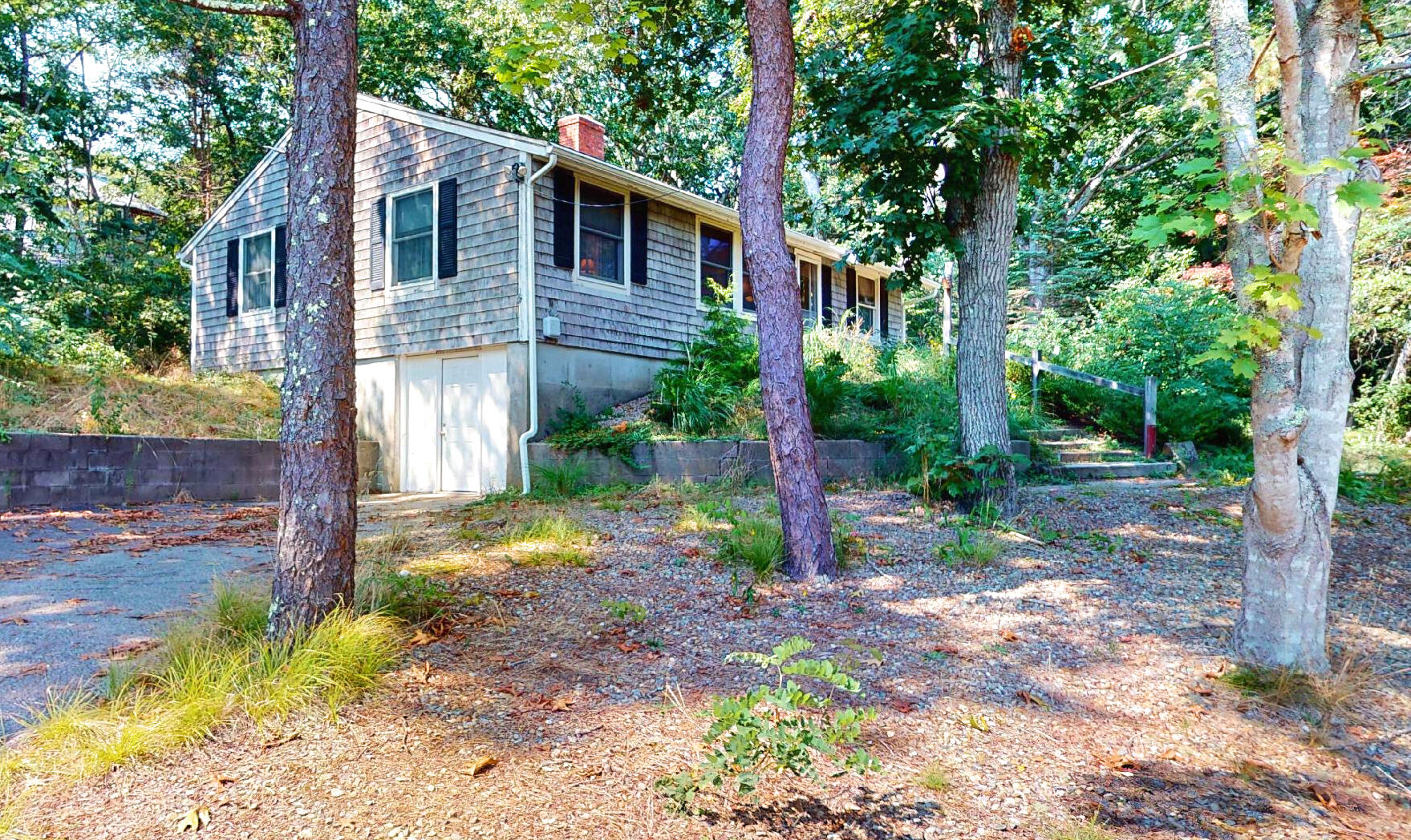 6 South Highland Road Truro, MA 02666 - Photo 27 of 27 a view of a yard in front of a house with large trees