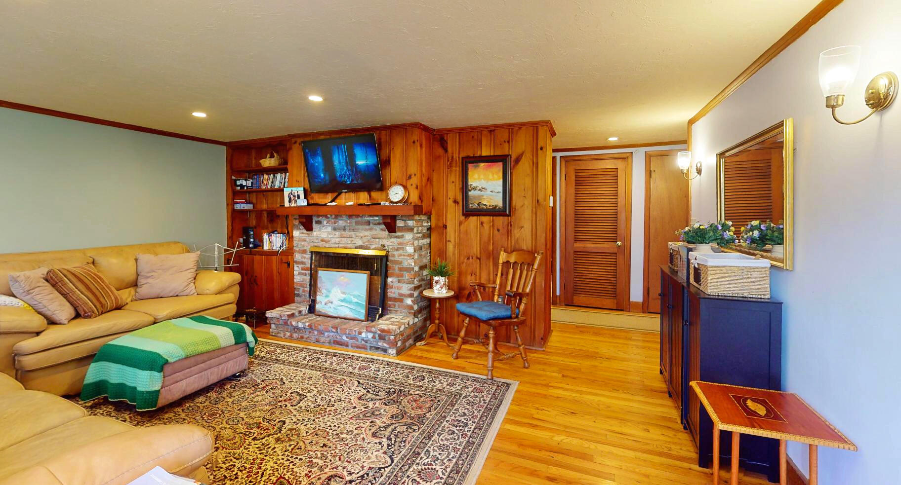 6 South Highland Road Truro, MA 02666 - Photo 5 of 27 a living room with furniture a rug and a fireplace