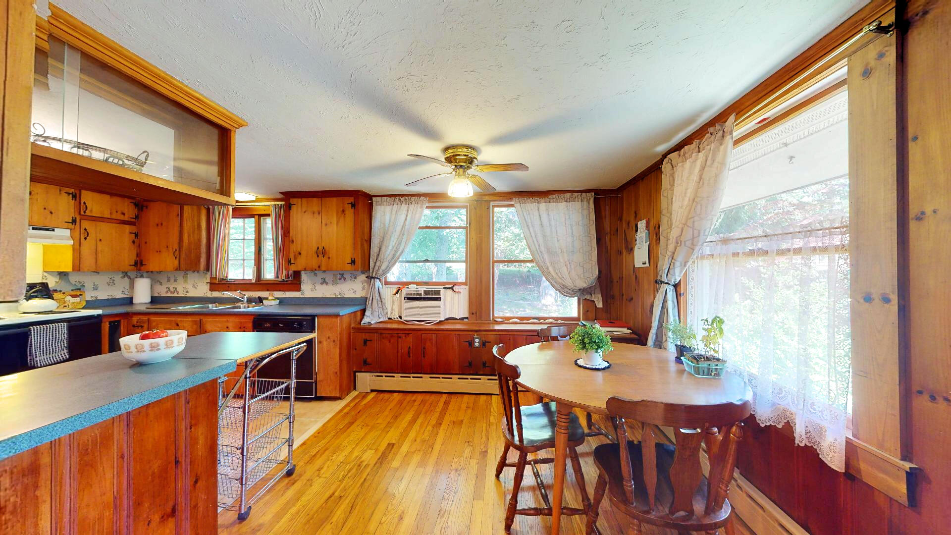 6 South Highland Road Truro, MA 02666 - Photo 8 of 27 a kitchen with stainless steel appliances wooden floor dining table and chairs
